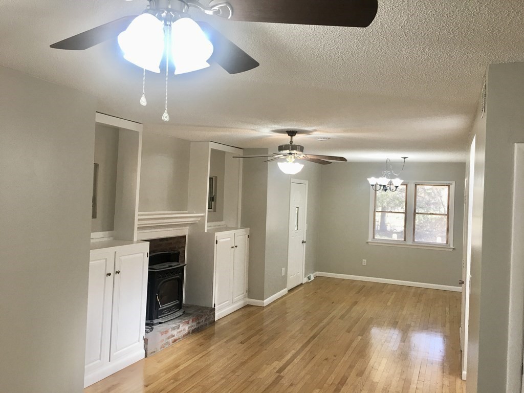 945 Tinkham Road Wilbraham, MA 01095 - Photo 8 of 26 wooden floor in an empty room with a window