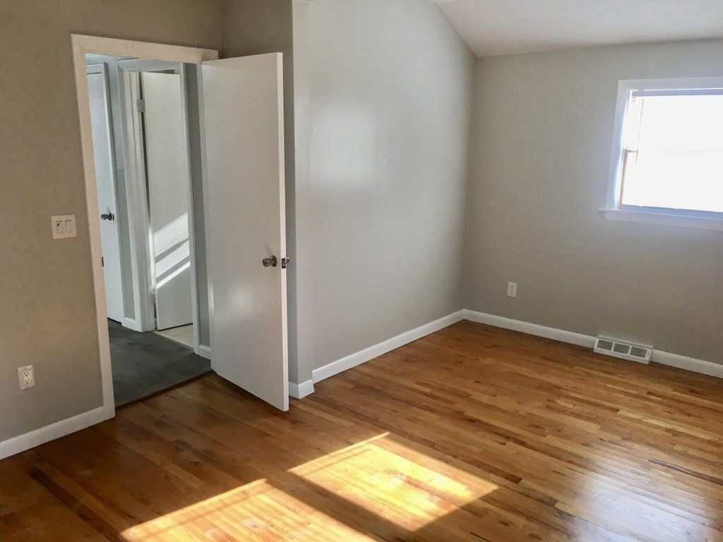945 Tinkham Road Wilbraham, MA 01095 - Photo 10 of 26 a view of empty room with wooden floor and cabinet