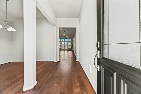 a view of hallway with wooden floor