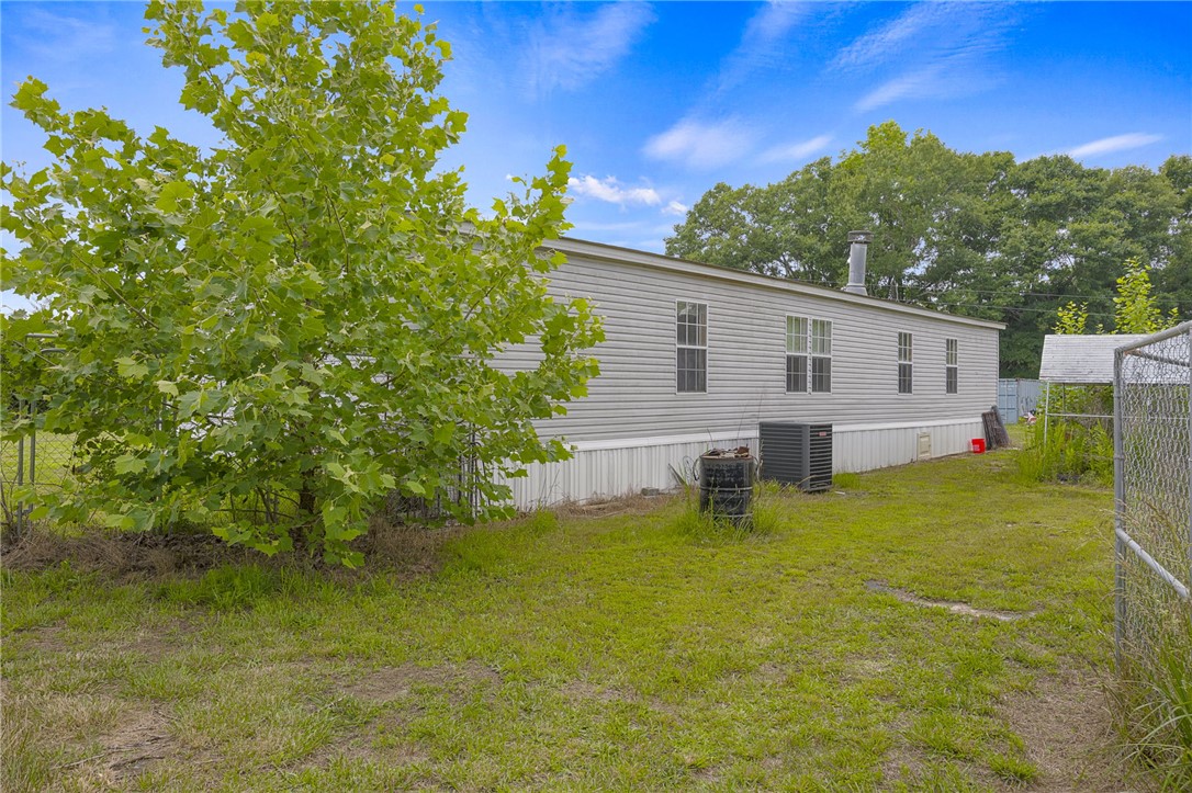 1549 Bethany Church Road Belton, SC 29627 - Photo 13 of 36 A well-maintained manufactured home sits peacefully amidst a natural setting, offering a tranquil escape.