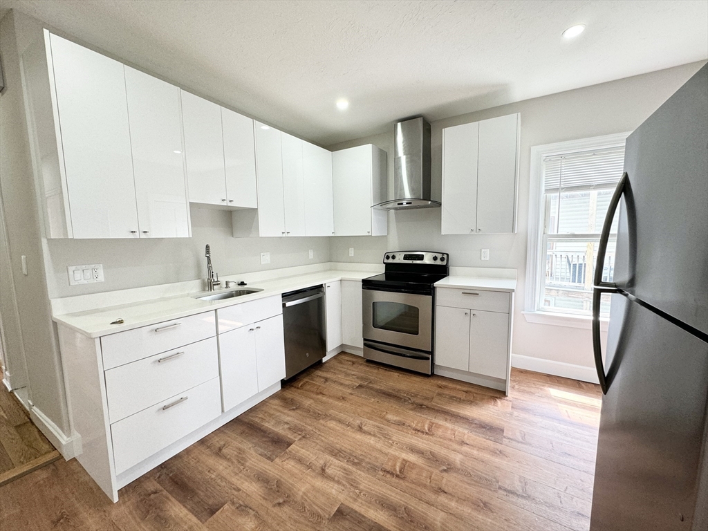 a kitchen with a white cabinets and white appliances