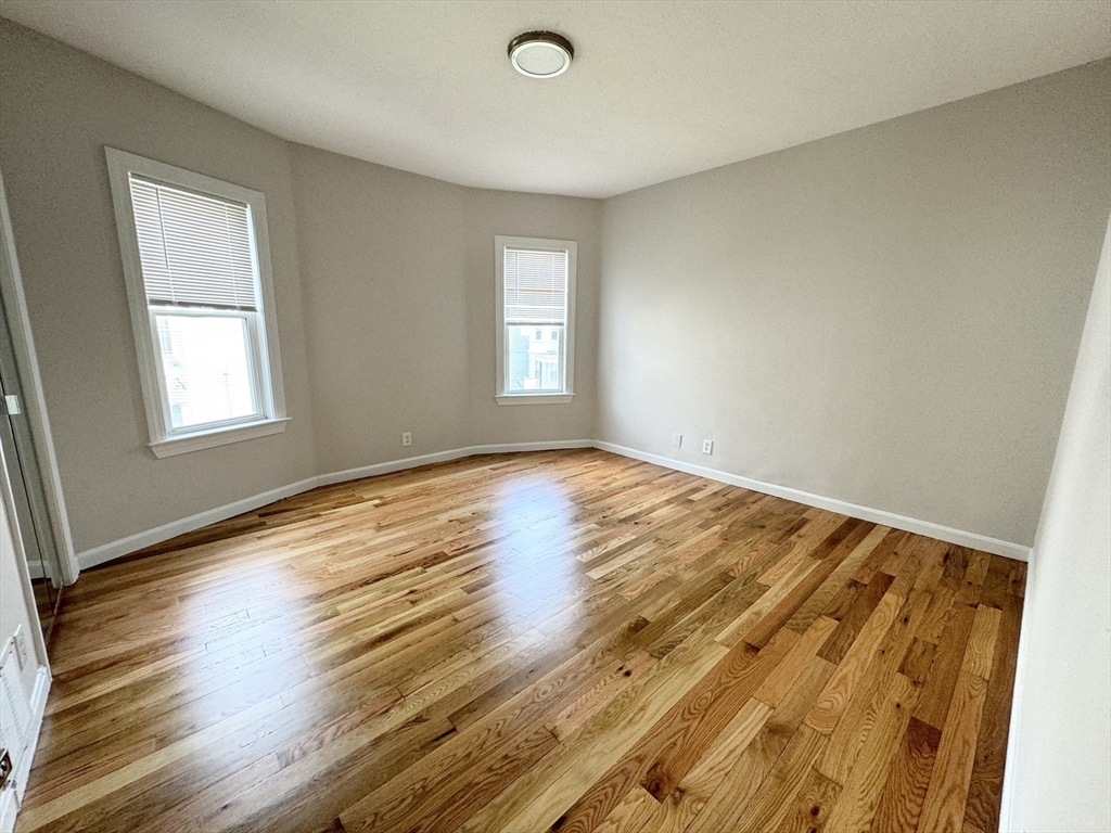 6 Cawfield Street, Unit 2 Boston, MA 02125 - Photo 4 of 8 a view of empty room with wooden floor and fan