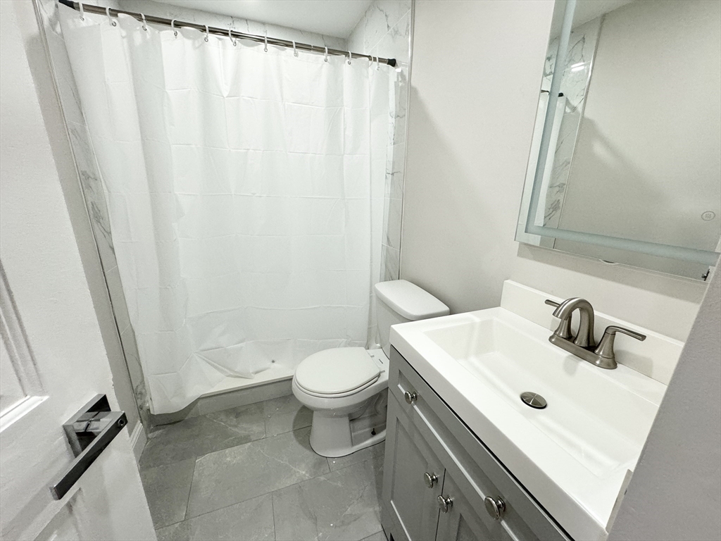 6 Cawfield Street, Unit 2 Boston, MA 02125 - Photo 7 of 8 a bathroom with a sink toilet and shower