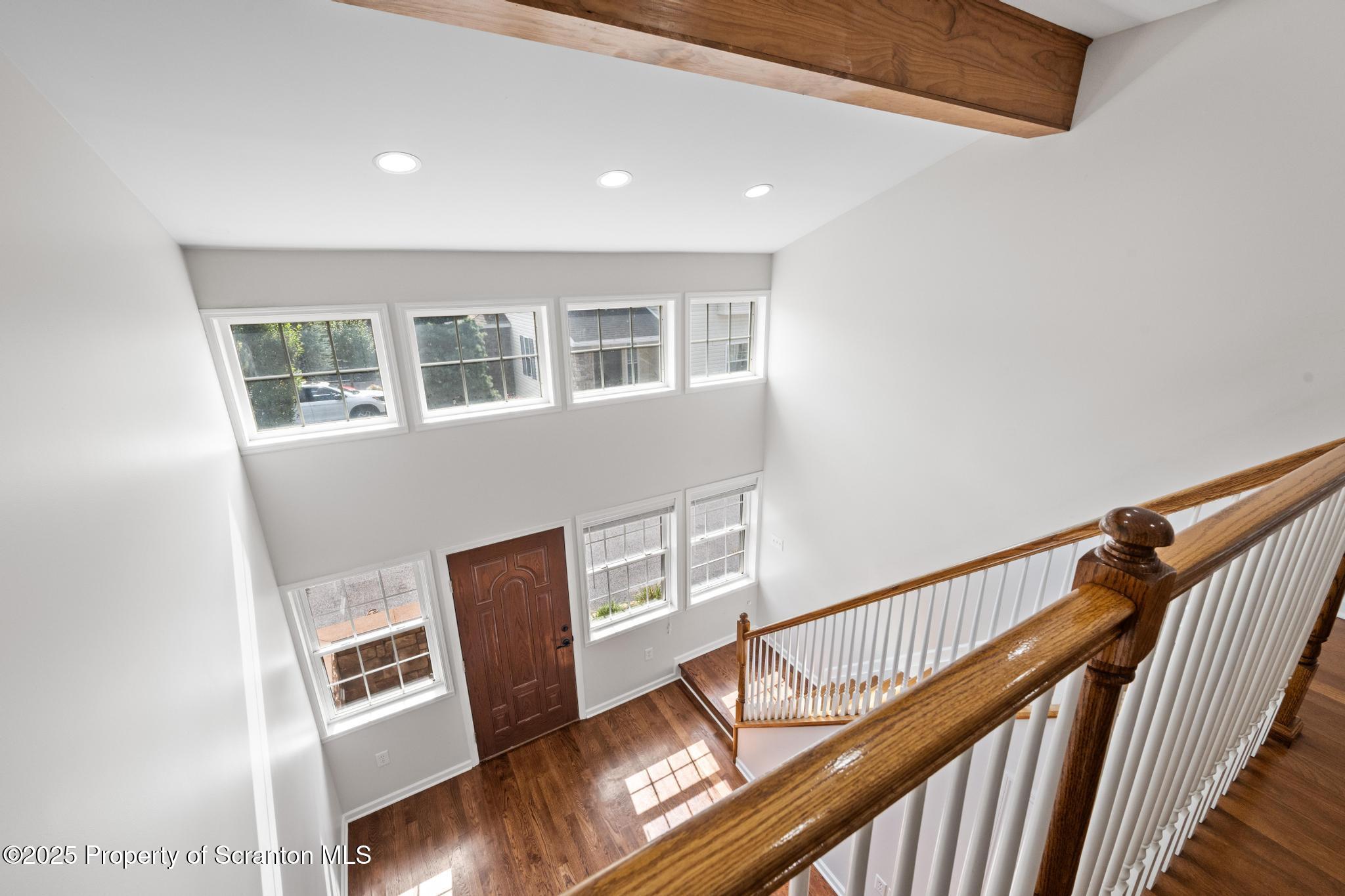 609 Edith Street Old Forge, PA 18518 - Photo 13 of 25 a view of an empty room with wooden floor and windows