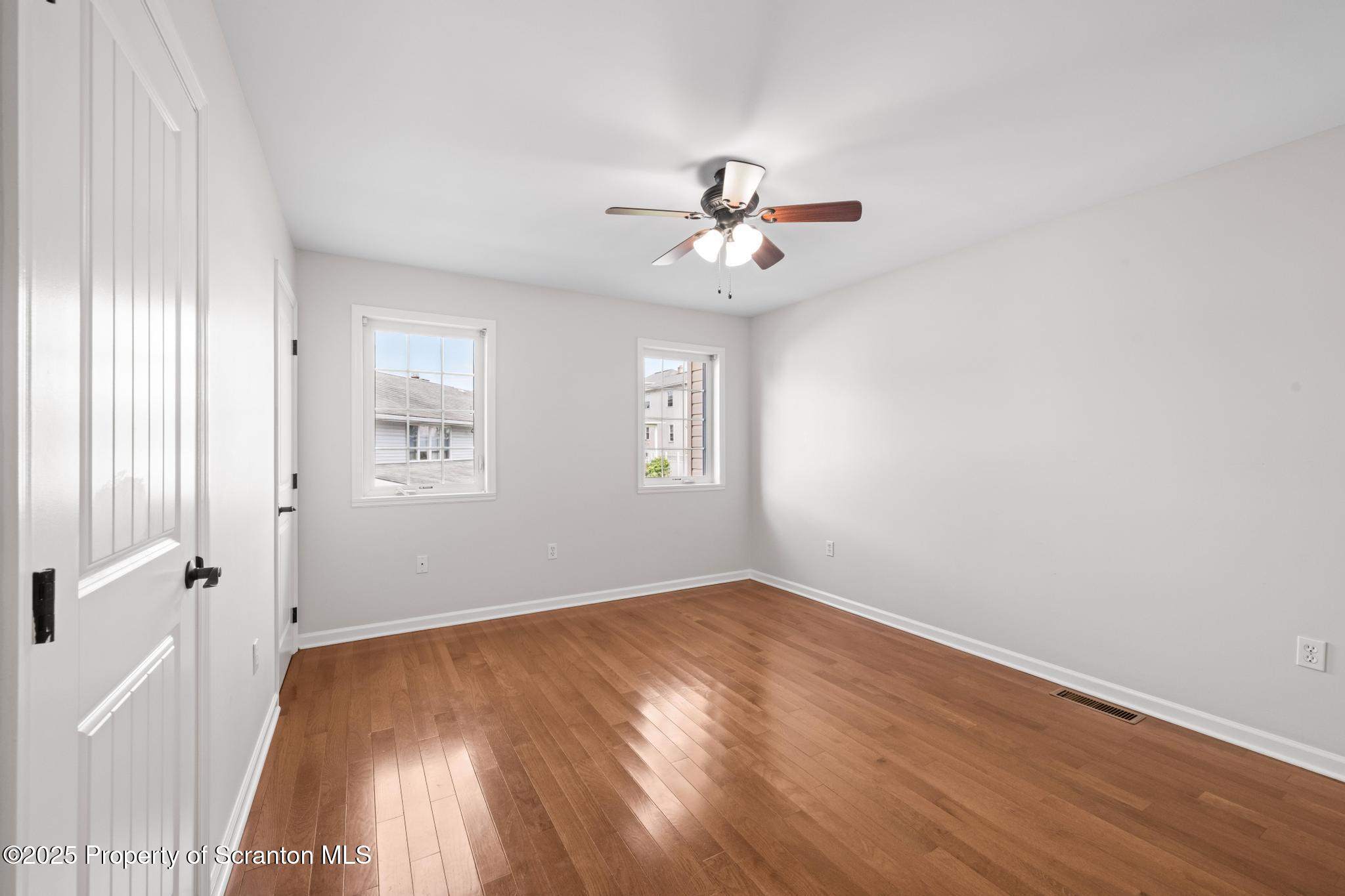609 Edith Street Old Forge, PA 18518 - Photo 17 of 25 a view of a big room with wooden floor and windows in a room