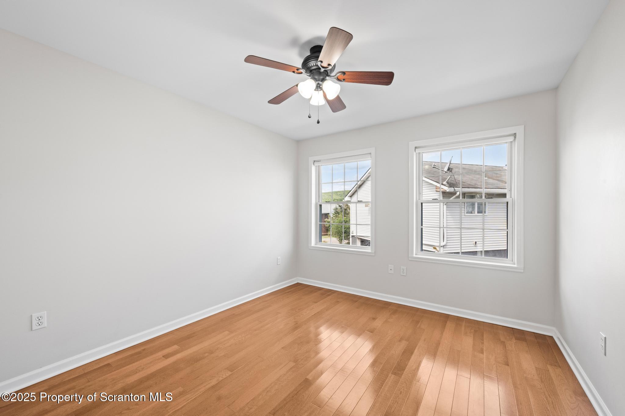 609 Edith Street Old Forge, PA 18518 - Photo 18 of 25 a view of an empty room with wooden floor and a window