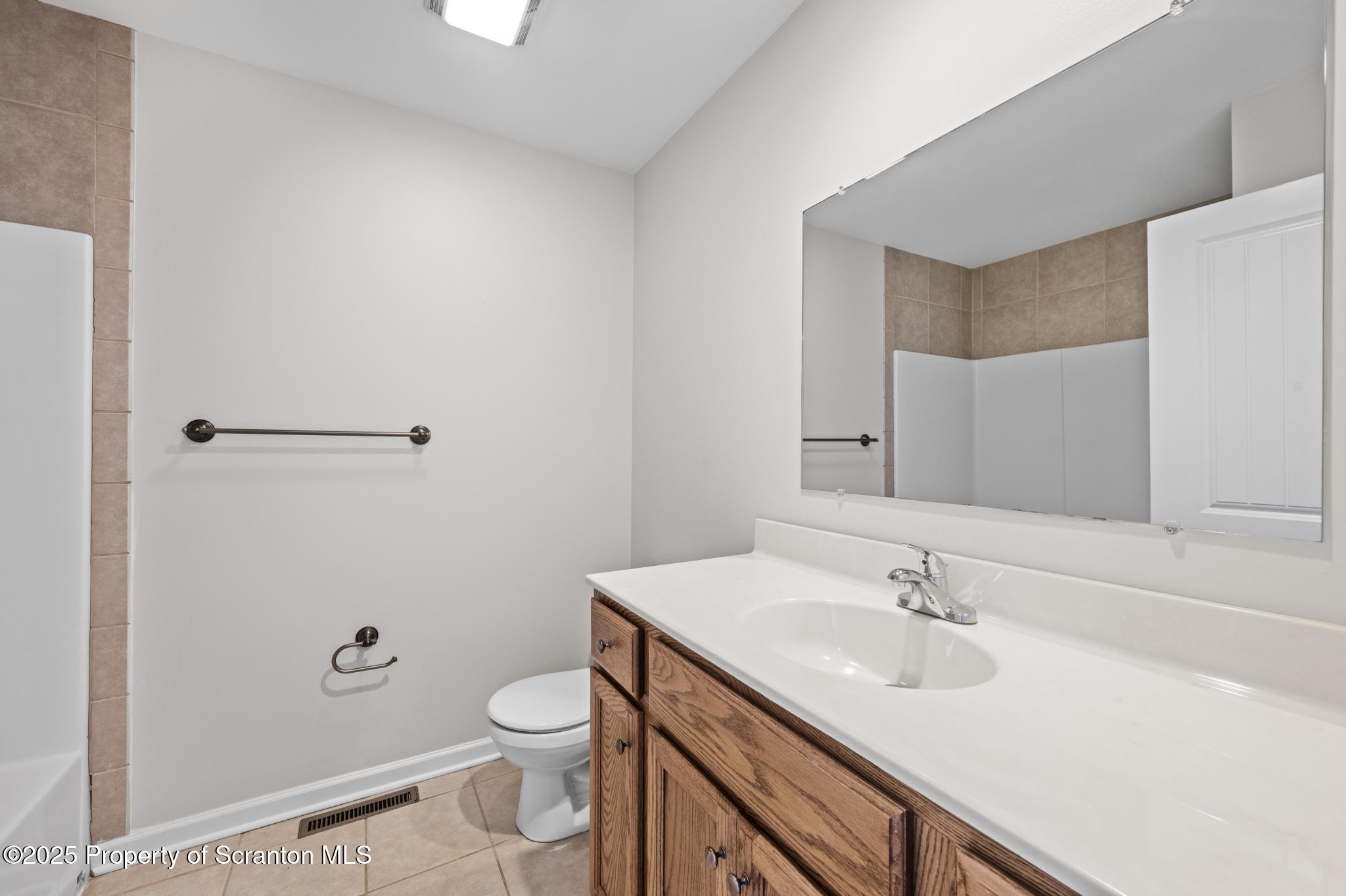 609 Edith Street Old Forge, PA 18518 - Photo 19 of 25 a bathroom with a sink toilet and vanity