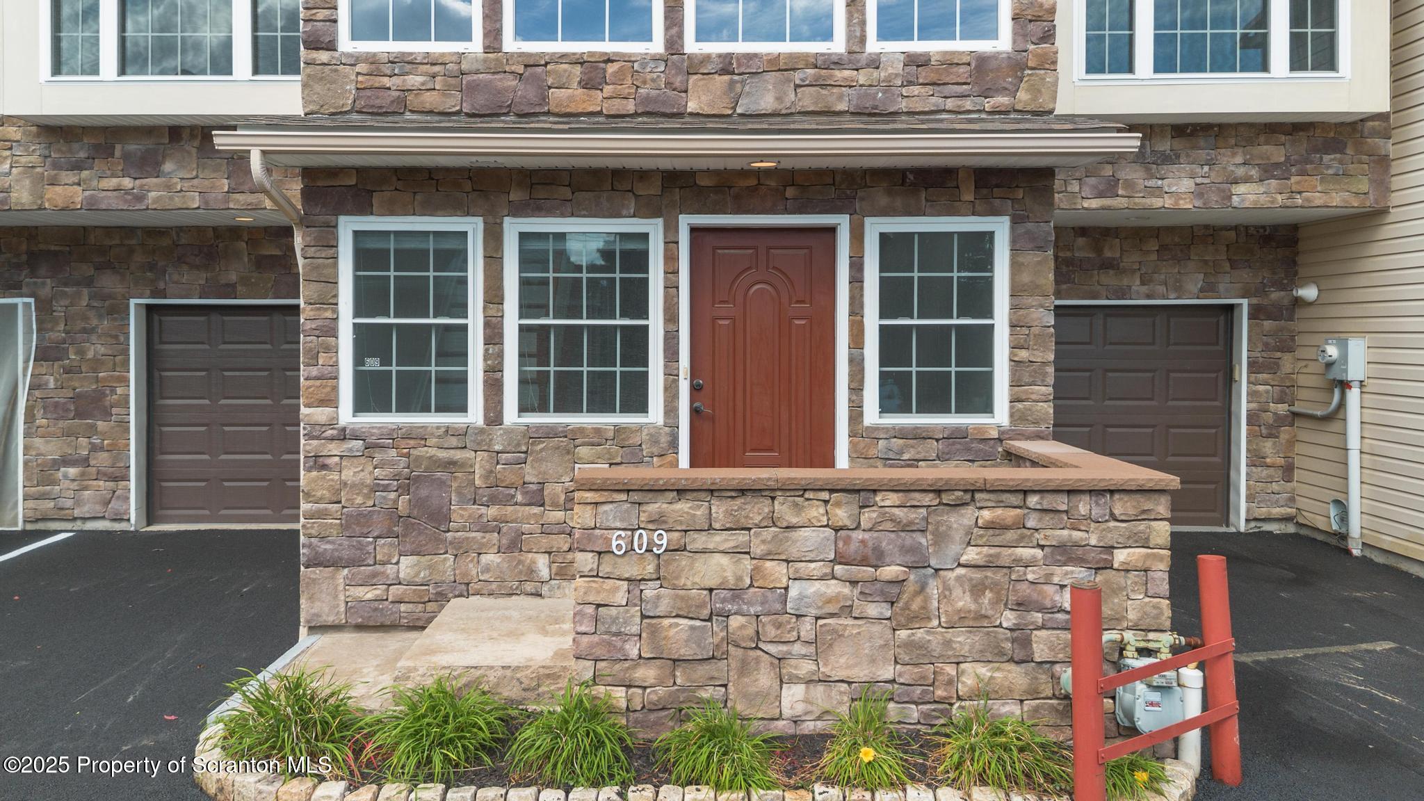 609 Edith Street Old Forge, PA 18518 - Photo 2 of 25 a front view of a house with a garden