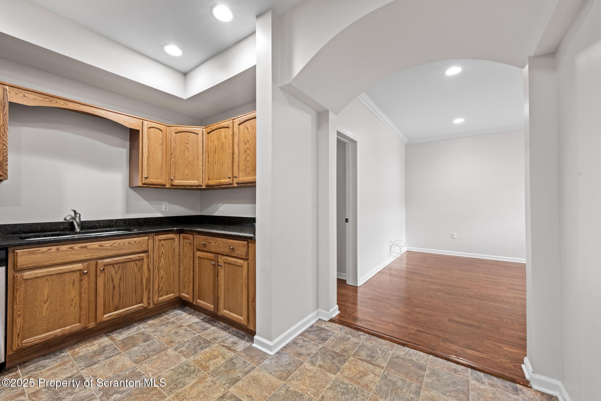 609 Edith Street Old Forge, PA 18518 - Photo 6 of 25 a kitchen with granite countertop a sink and cabinets