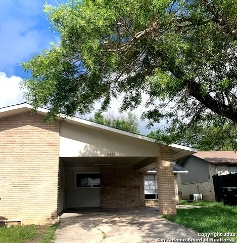 a view of a car park in front of a house