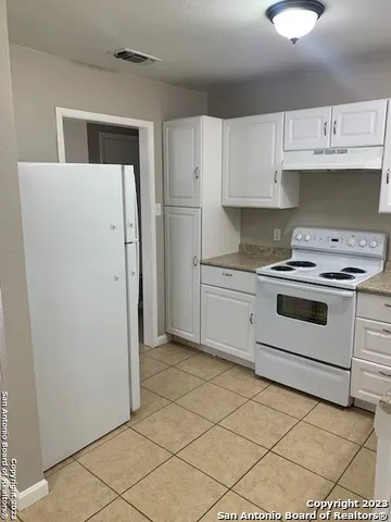 a kitchen with cabinets and appliances