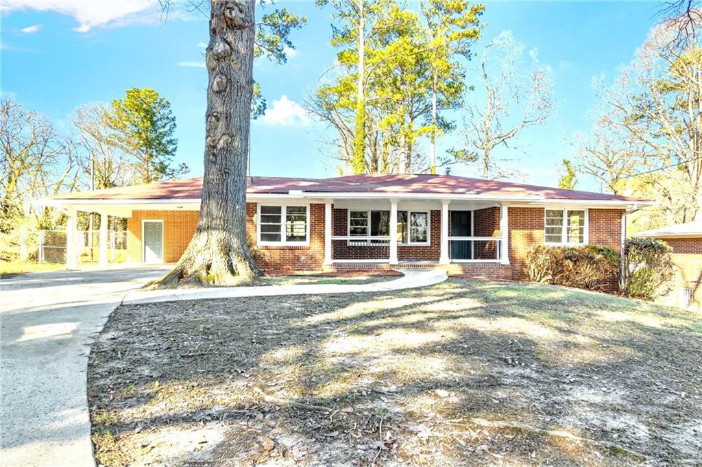 2393 Lilla Circle Southwest Atlanta, GA 30310 - Photo 1 of 1 a view of a house with a backyard and a tree