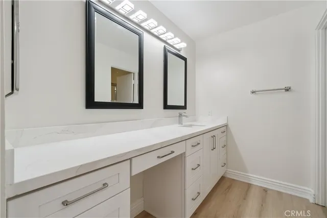 a bathroom with a granite countertop toilet and a shower