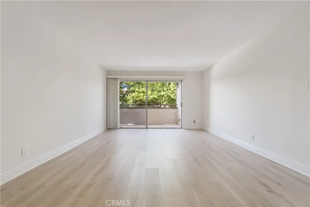 a kitchen with granite countertop wood cabinets stainless steel appliances and a sink