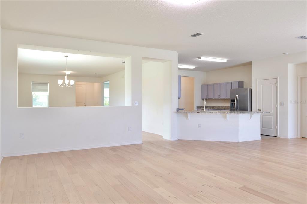 2164 Carriage Pointe Loop Apopka, FL 32712 - Photo 14 of 30 a view of kitchen with refrigerator and white cabinets