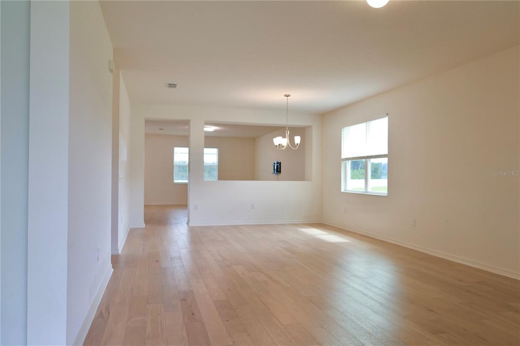 2164 Carriage Pointe Loop Apopka, FL 32712 - Photo 7 of 30 an empty room with wooden floor and windows