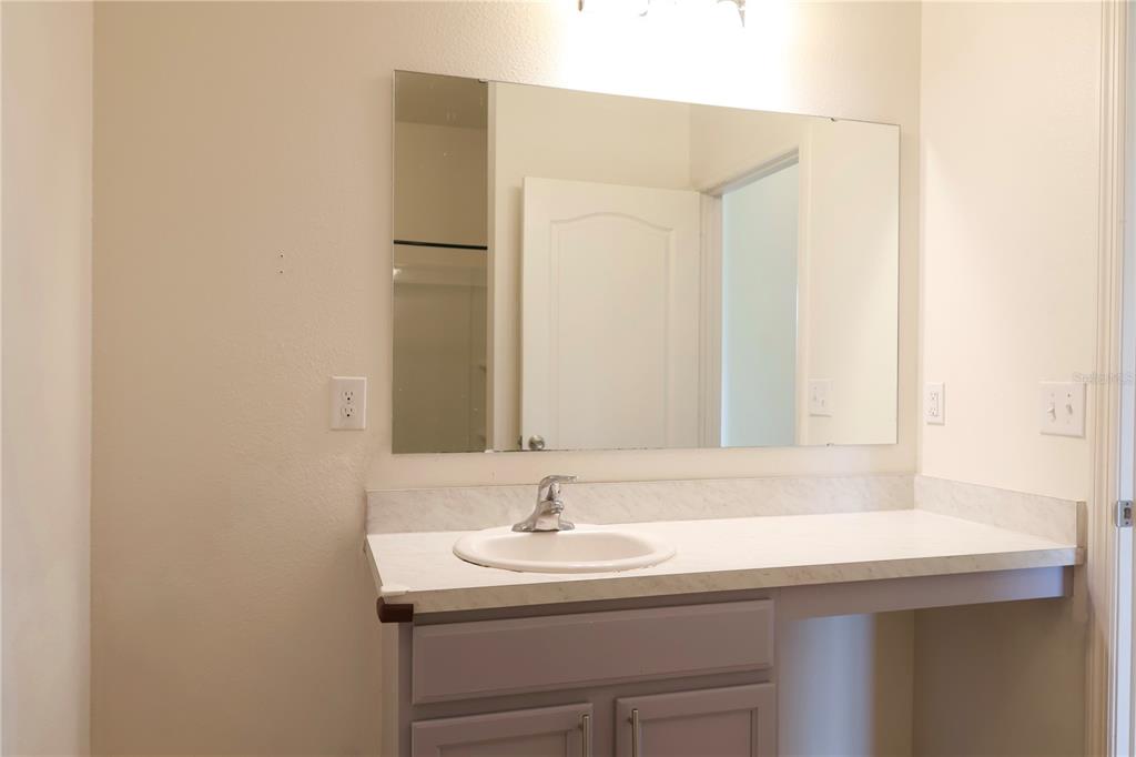 2164 Carriage Pointe Loop Apopka, FL 32712 - Photo 8 of 30 a bathroom with a sink and a mirror