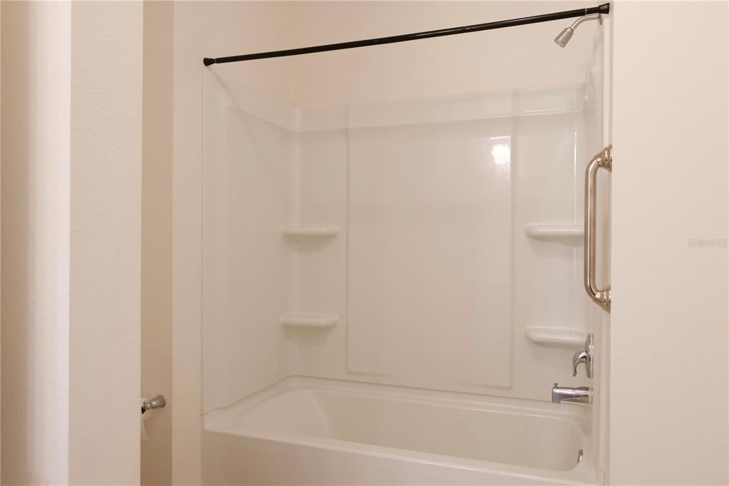 2164 Carriage Pointe Loop Apopka, FL 32712 - Photo 9 of 30 a bathroom with a shower and a bath tub