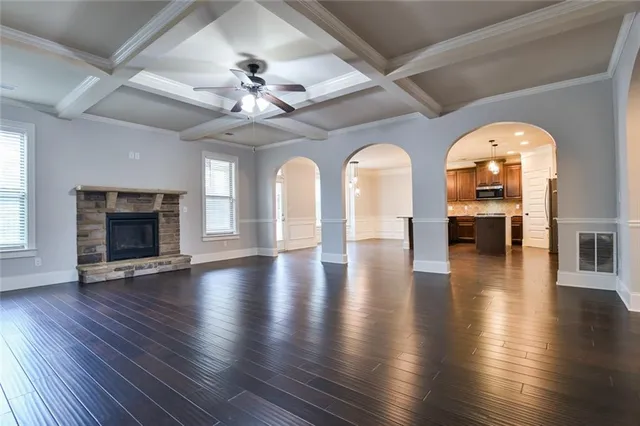 a view of a hall with wooden floor and a ceiling fan