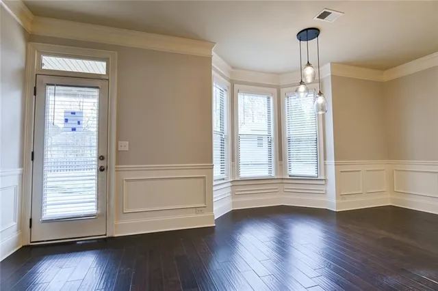 a kitchen with stainless steel appliances granite countertop a sink a stove and a wooden floors