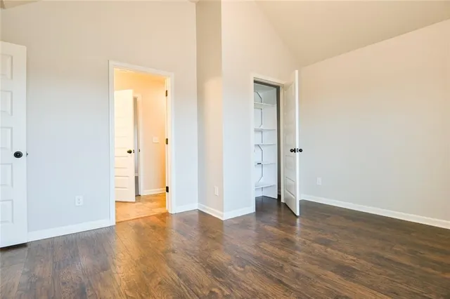 a view of a hallway with wooden floor and chandelier