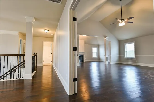 a view of a hallway with wooden floor