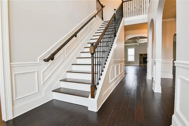 a view of staircase with white walls and windows