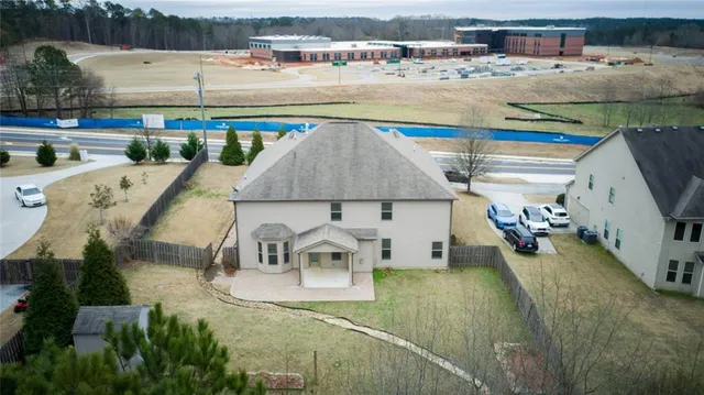 an aerial view of a house with outdoor space and lake view