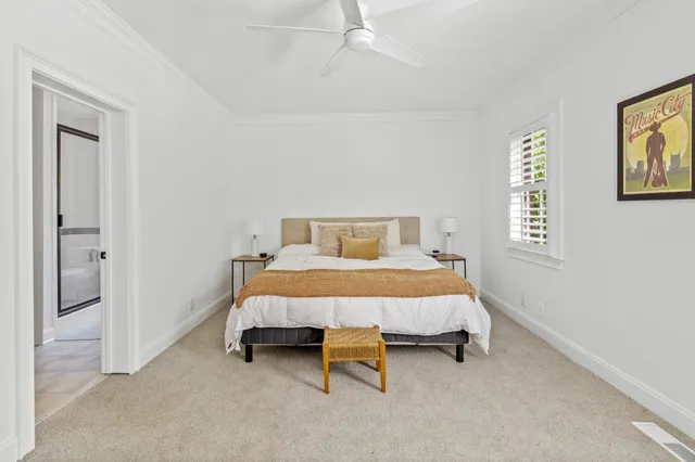 a bed sitting in a bedroom next to a window