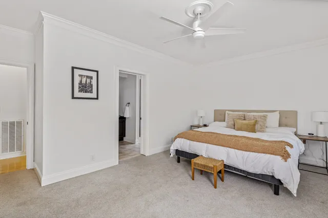 a bedroom with a bed and a ceiling fan