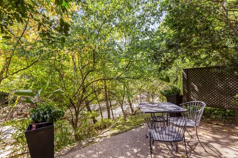 a backyard of a house with table and chairs