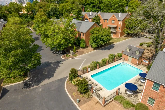 an aerial view of a house with a garden and swimming pool