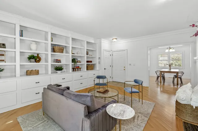 a living room with furniture a dining table and kitchen view
