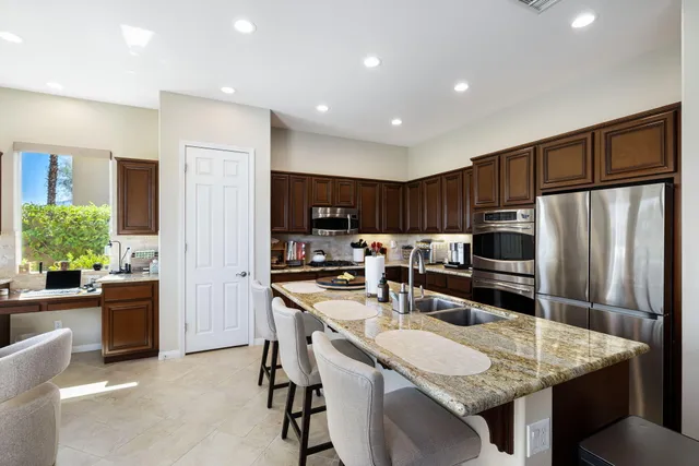 a view of a patio with a table and chairs