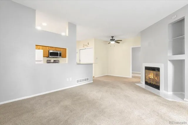 a view of a livingroom with an empty space and a fireplace