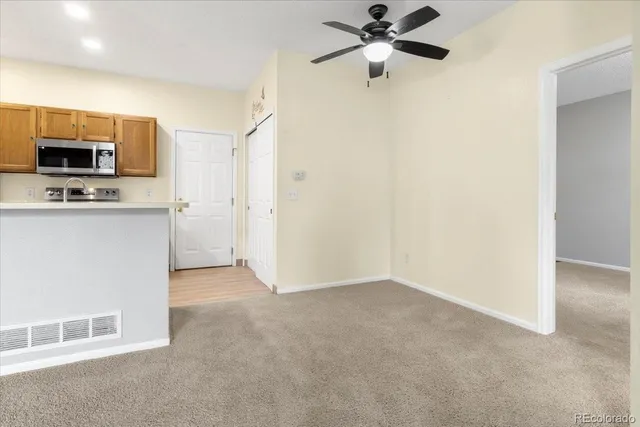 a view of a kitchen with a sink and a refrigerator