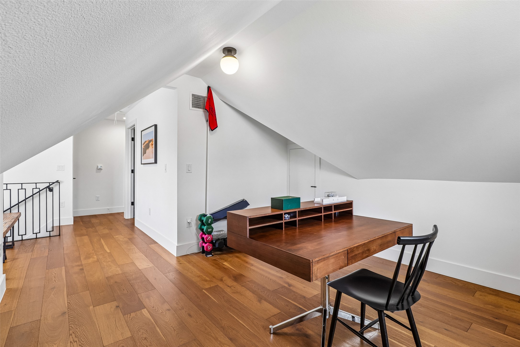 1706 Perez Street, Unit 1 Austin, TX 78721 - Photo 21 of 36 Hardwood floors and sloped ceilings define this versatile attic space.