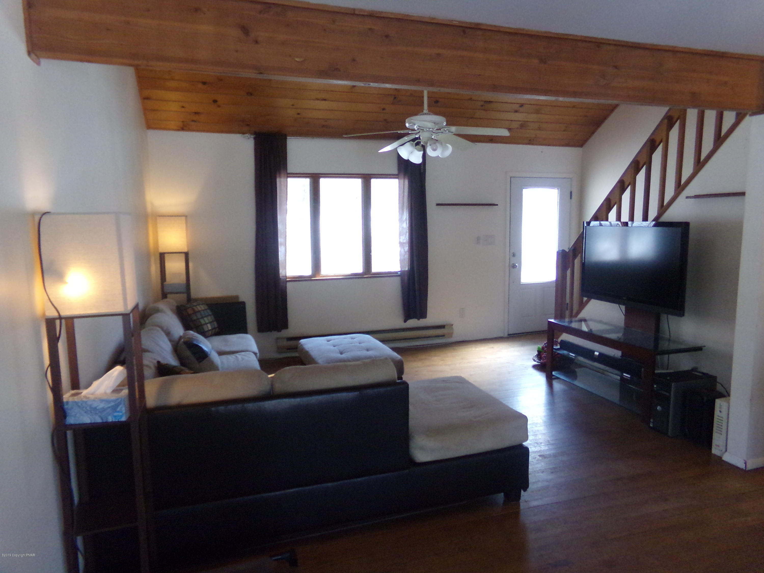 1193 Bear Drive Bushkill, PA 18324 - Photo 12 of 29 a bedroom with a bed and a flat screen tv
