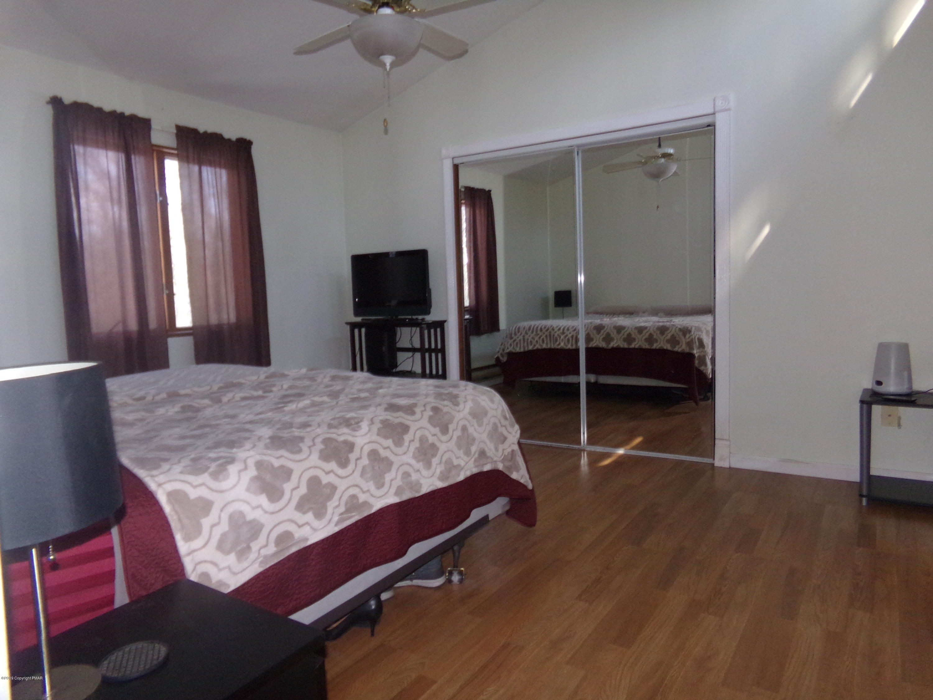 1193 Bear Drive Bushkill, PA 18324 - Photo 19 of 29 a bedroom with a bed and a television