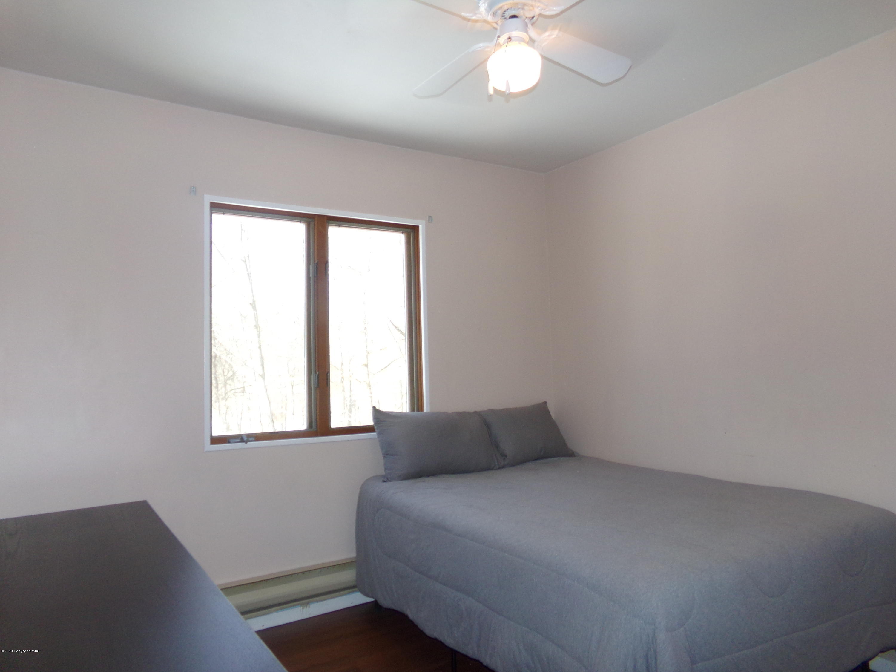 1193 Bear Drive Bushkill, PA 18324 - Photo 22 of 29 a bedroom with a bed and a window