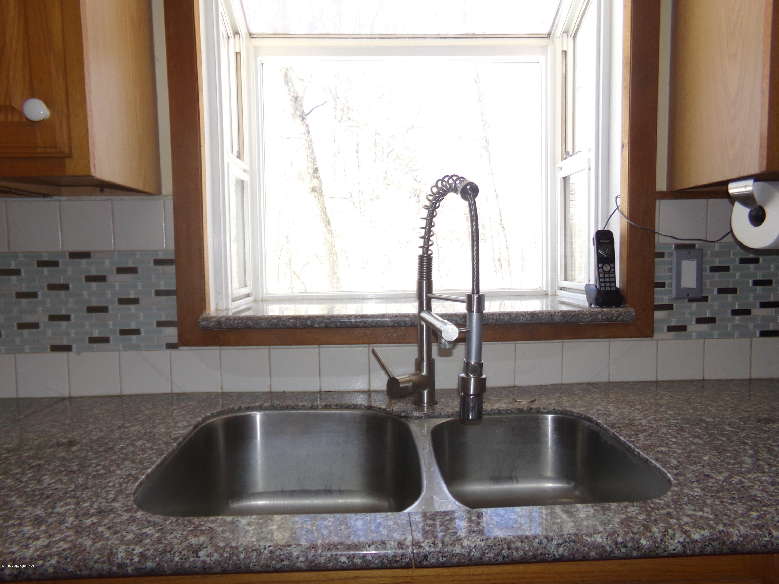 1193 Bear Drive Bushkill, PA 18324 - Photo 8 of 29 a kitchen view with granite countertop a sink and a window