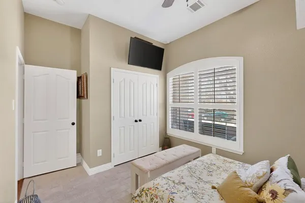 a bedroom with a bed and a window