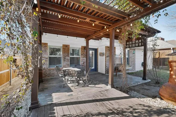 a view of a porch with furniture and wooden fence