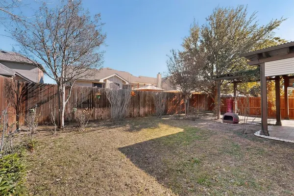 a backyard of a house with barbeque oven and outdoor seating