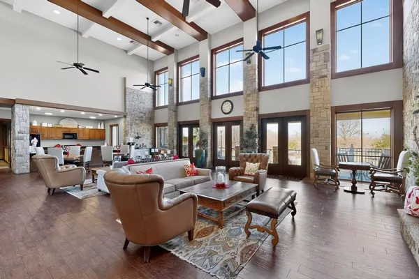 a living room with patio furniture and a large window