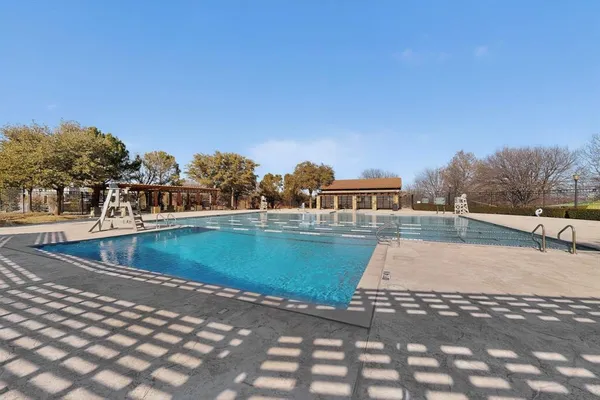 a view of a swimming pool with a yard