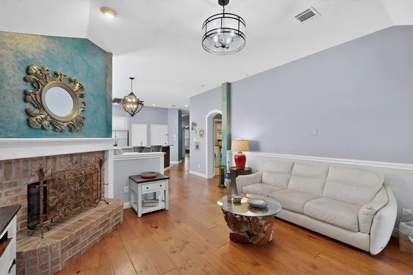 a living room with furniture a rug and white walls