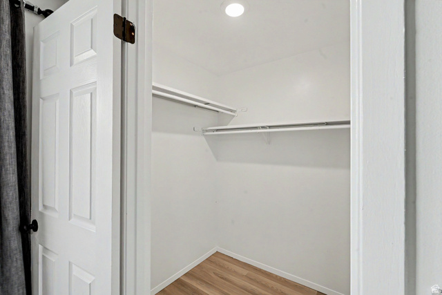 3689 Lasso Loop Circle Magna, UT 84044 - Photo 14 of 26 Closet with wood-finish flooring, white walls, and built-in shelving