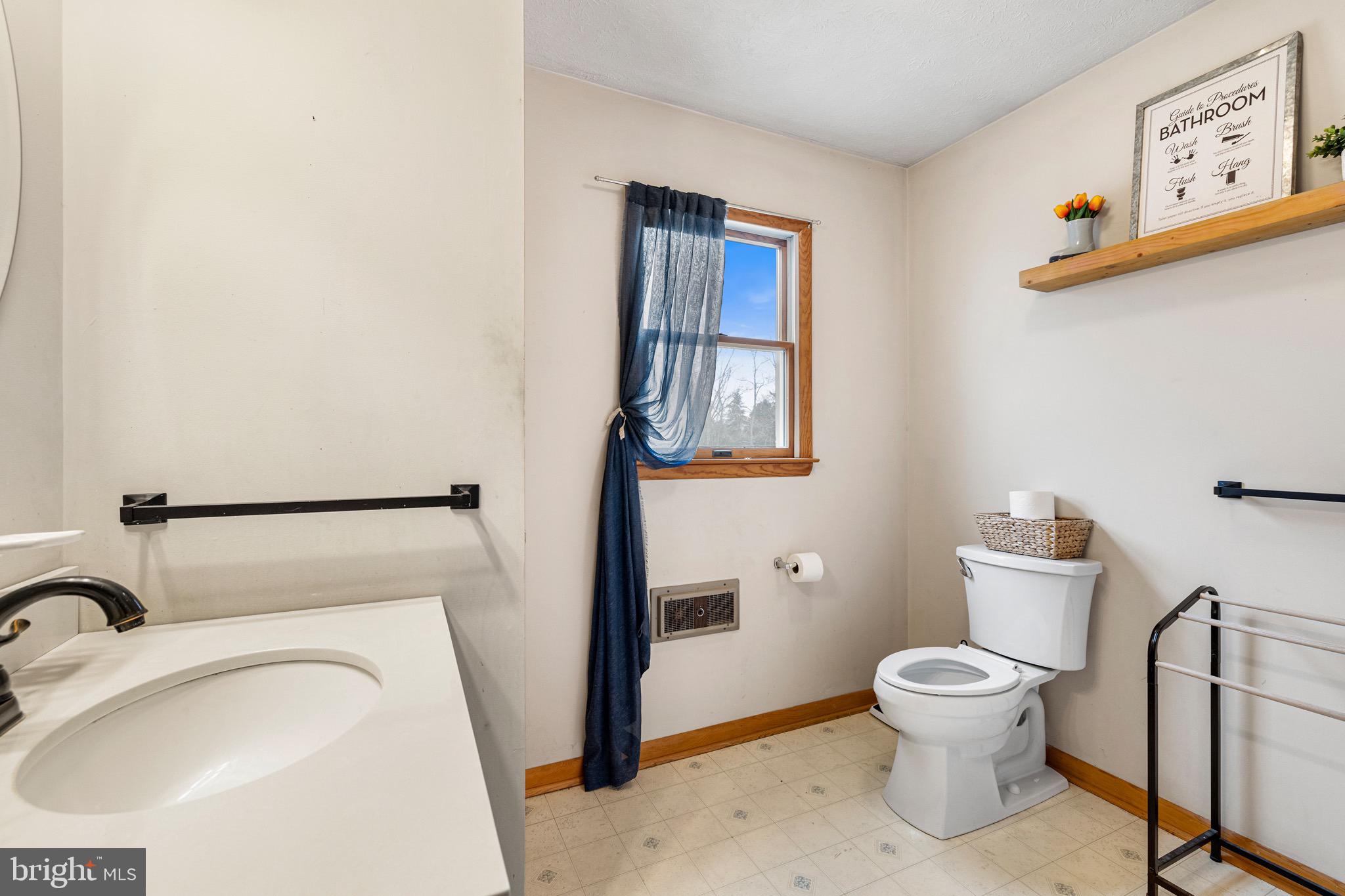 3360 Senedo Road Quicksburg, VA 22847 - Photo 14 of 58 a white toilet sitting next to a bathroom sink