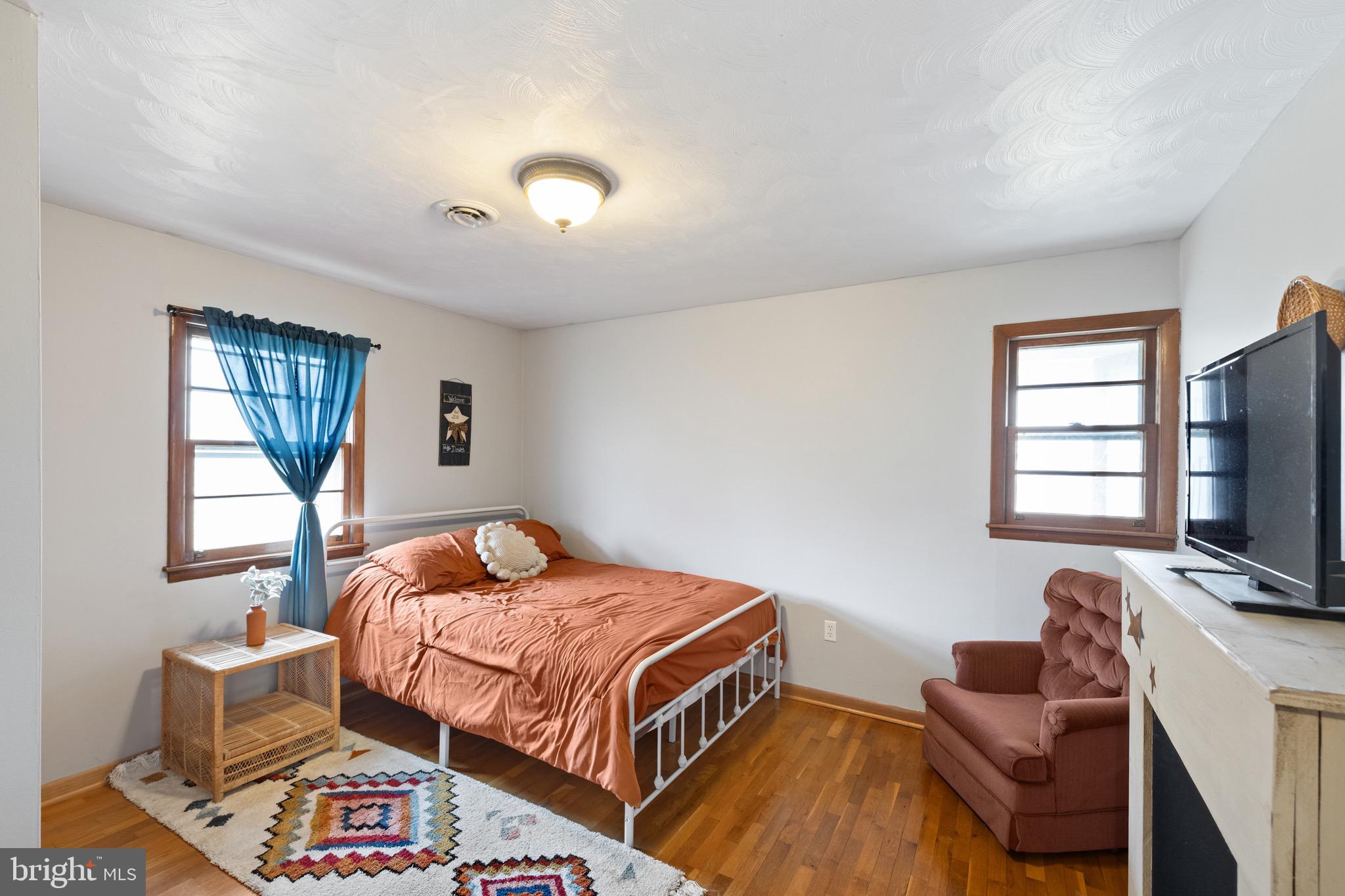 3360 Senedo Road Quicksburg, VA 22847 - Photo 18 of 58 a bedroom with a bed and flat screen tv